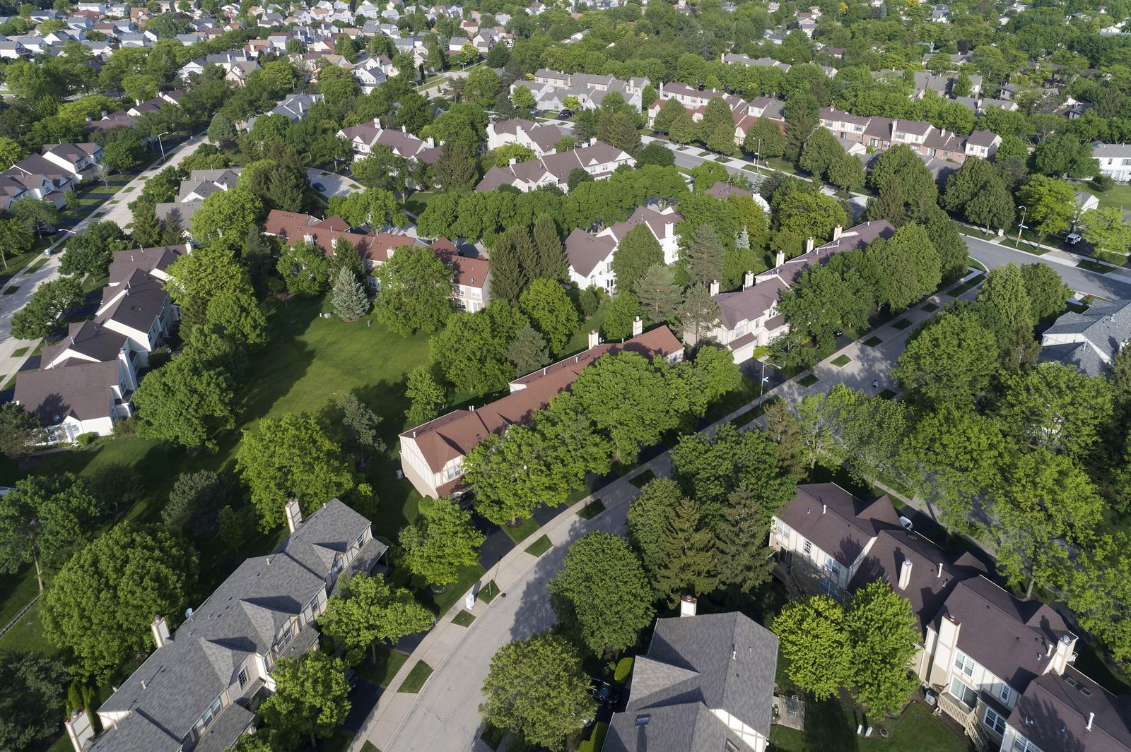 Row of townhomes in Lisle with new shingle roofs and gutters